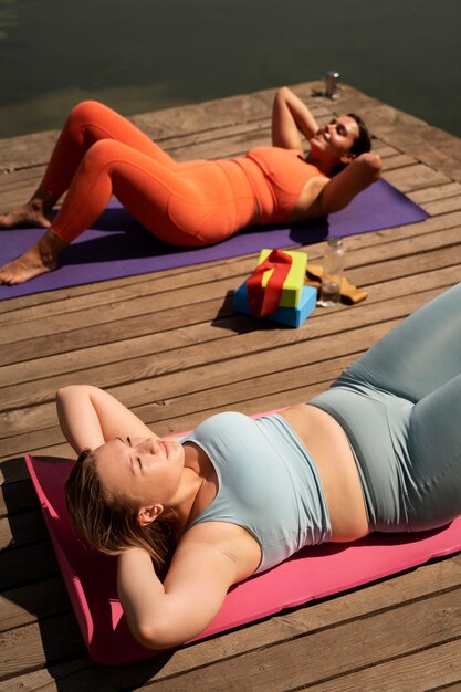 High angle women on yoga mats