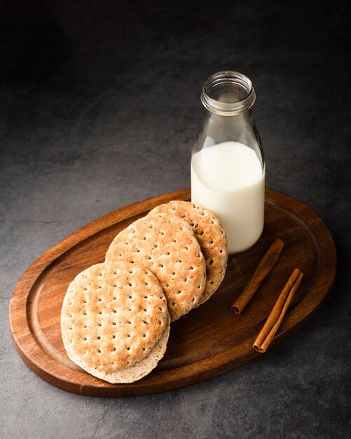 High angle wood tray with milk and biscuits