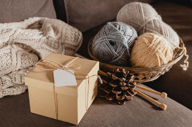 High angle wooden box with yarn and pine cone