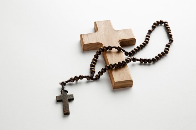 High angle wooden cross and rosary