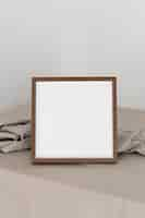 Free photo high angle wooden frame and cloth