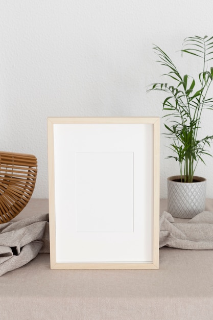 Free photo high angle wooden frame and plant