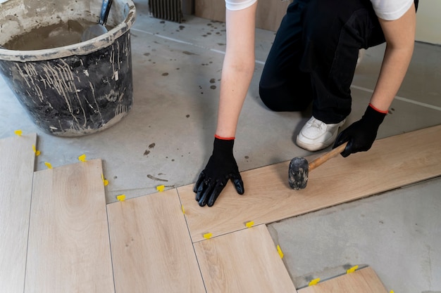 High angle worker tiling floor