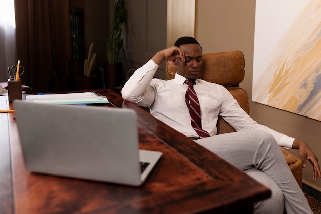 High angle worried man sitting on chair