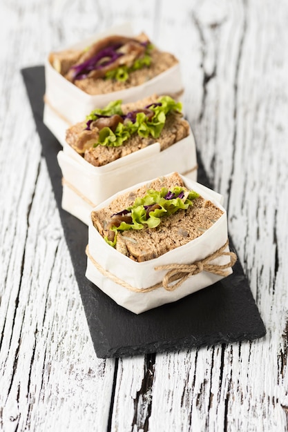 High angle of wrapped sandwiches on slate