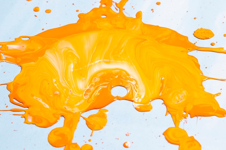 Free Photo high angle yellow paint on blue background