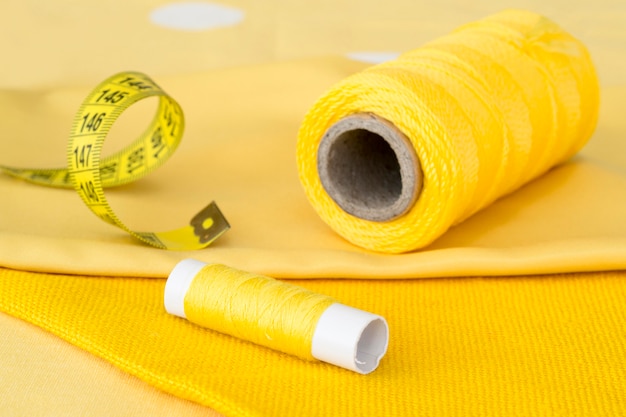 High angle of yellow thread rolls with textile