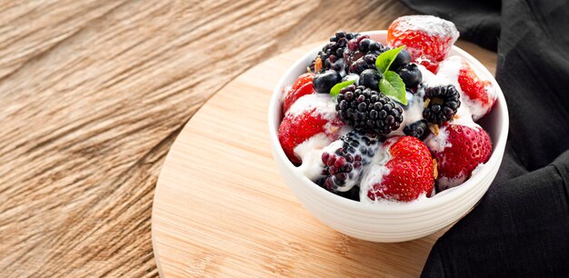 High angle yogurt bowl on wooden table