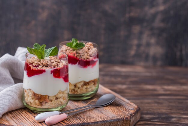 High angle of yogurt glasses with cereal and copy space