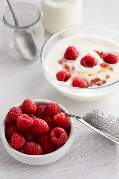 High angle  yogurt with raspberries
