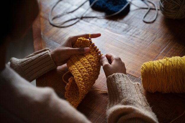 high angle young adult crocheting indoors