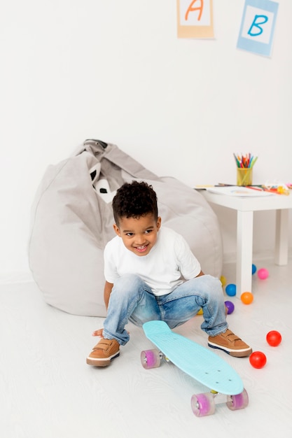 High angle of young boy with skateboard