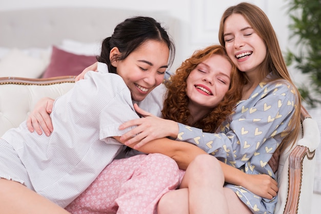 High angle young girlfriends hugging