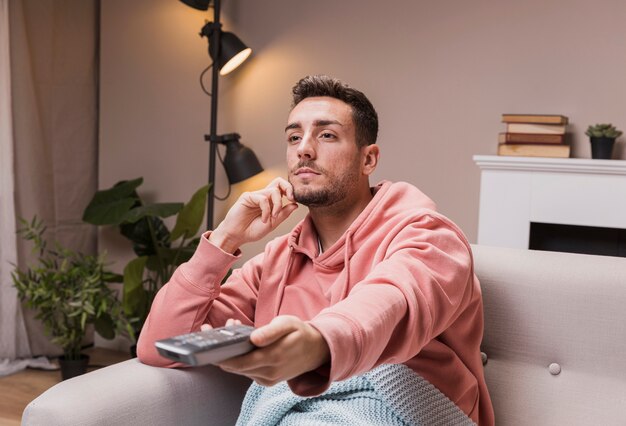 High angle young man holding remote