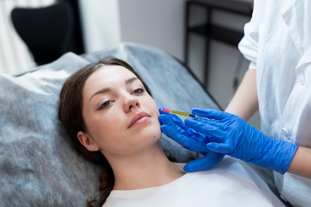 High angle young woman getting prp injection