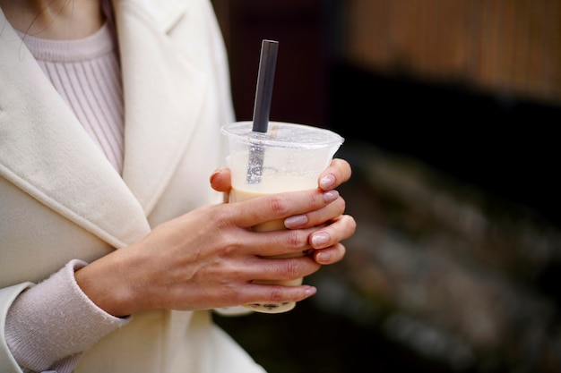 Free photo high angle young woman with bubble tea