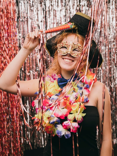 High angle young woman with mask at carnival party