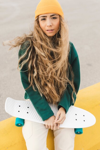 High angle young woman with skateboard