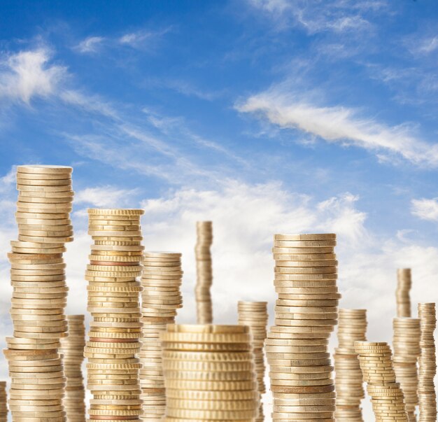 high coin towers representing the richness under a blue sky