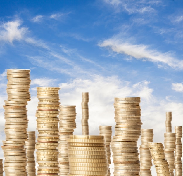 high coin towers representing the richness under a blue sky