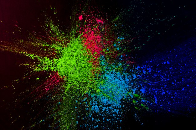 High colorful powder color splatted on dark background