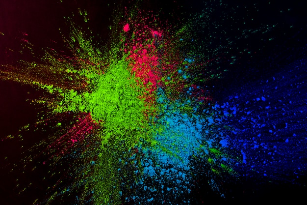 High colorful powder color splatted on dark background