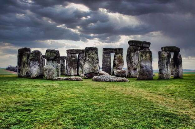 High contrast shot of the Stonehenge stones in Sailsbury UK on cloudy rainy day with green grass