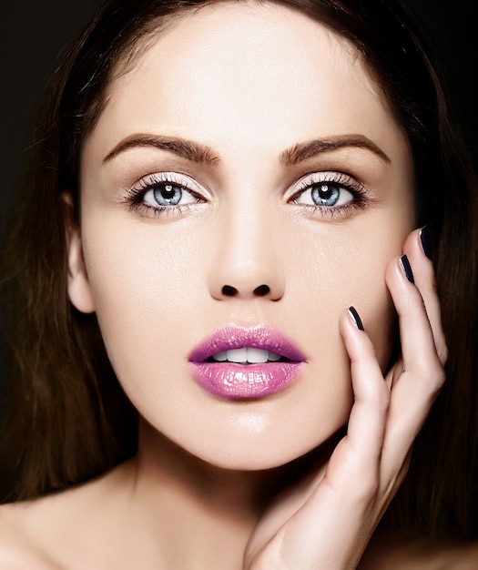 High fashion look.glamor closeup beauty portrait of beautiful   Caucasian young woman model with nude makeup   with perfect clean skin with colorful pink lips