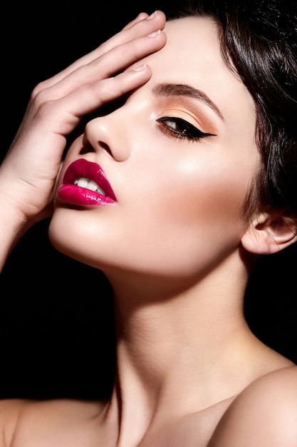 High fashion look.glamor closeup portrait of beautiful sexy brunette Caucasian young woman model with bright makeup, with red lips,  with perfect clean  skin