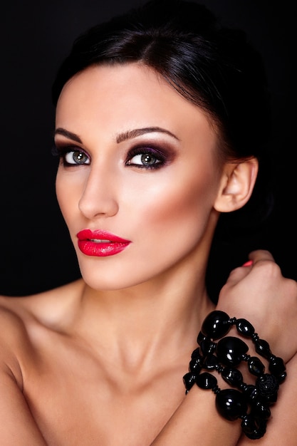 Free photo high fashion look.glamor closeup portrait of beautiful sexy caucasian young woman model with red lips,bright makeup, with perfect clean skin isolated on black