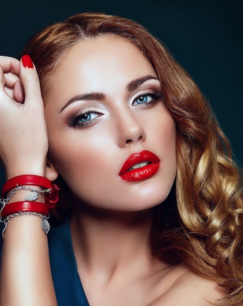 High fashion look.glamor closeup portrait of beautiful sexy stylish blond Caucasian young woman model with bright makeup, with red lips,  with perfect clean skin with colorful accessories