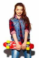 Free photo high fashion look.glamor stylish sexy beautiful young brunette woman model in summer bright hipster cloth with skateboard