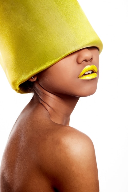 Free photo high fashion look.glamour fashion beautiful black american woman with yellow bright lips with yellow material on head isolated on white