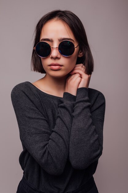High fashion portrait of young elegant woman in sunglasses isolated