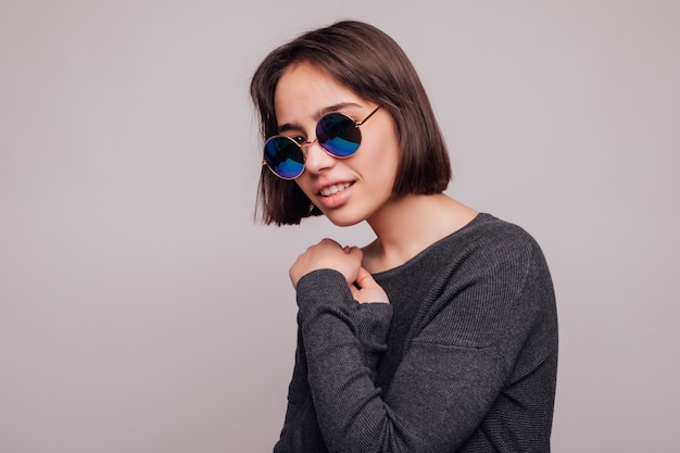 High fashion portrait of young elegant woman in sunglasses isolated