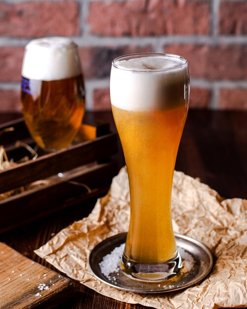 High glass of beer with foam