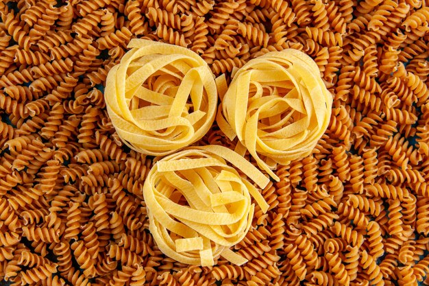 High resolution photo of various raw Italian pastas lined up in a row