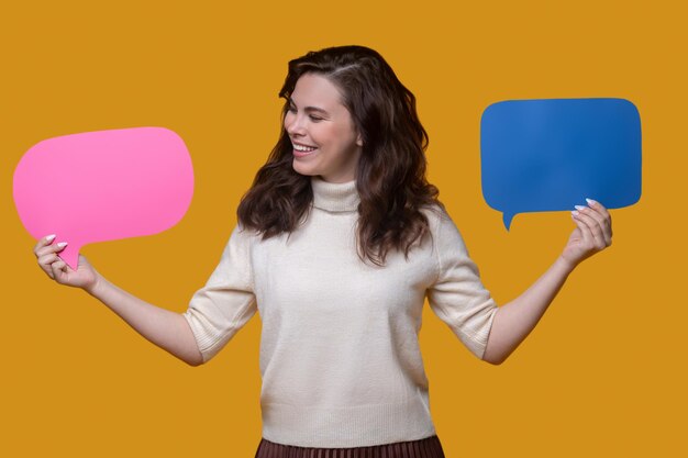 High-spirited woman holding empty question and answer signs