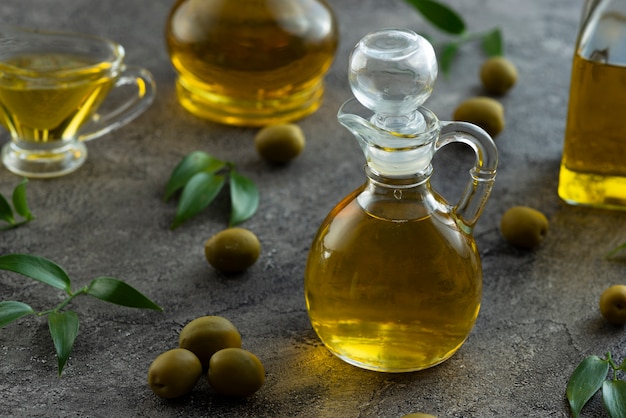 High view of bottles filled with olive oil on marble background