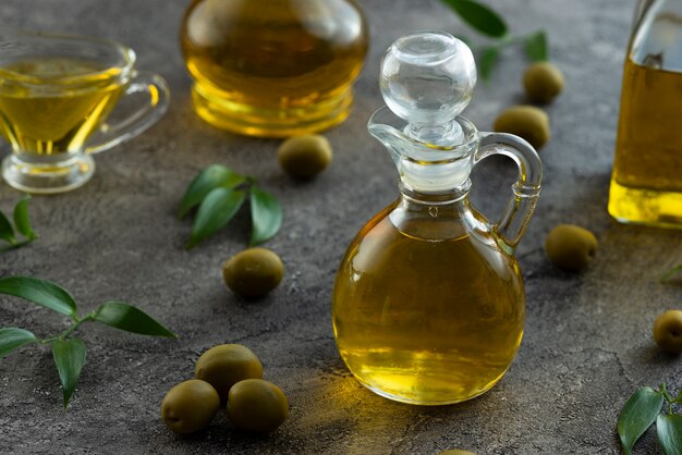 High view of bottles filled with olive oil on marble background