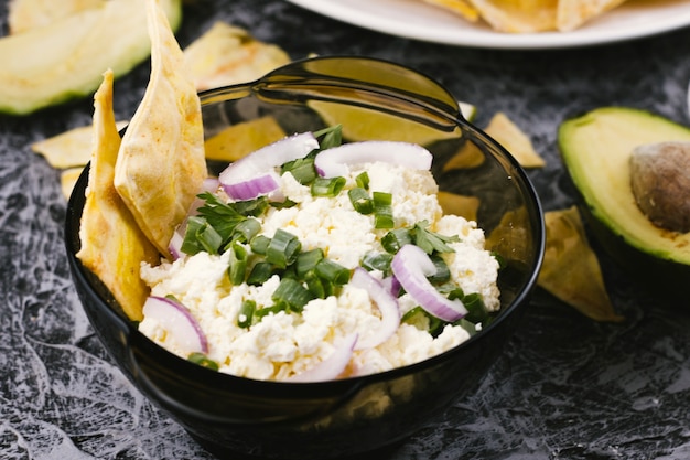 High view bowl of scrambled eggs and avocado