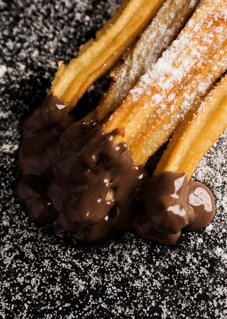 High view churros with sugar and chocolate