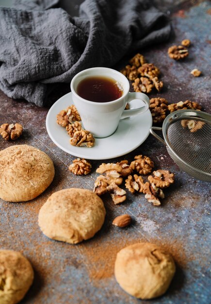 High view of cup with cookies and walnuts