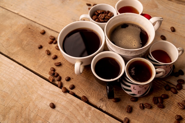 High view cups of coffee with wooden background