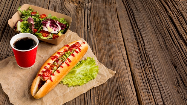 Free photo high view of delicious hot dog and salad