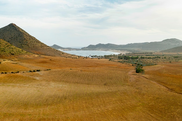 High view of dried field and mountains with lakes