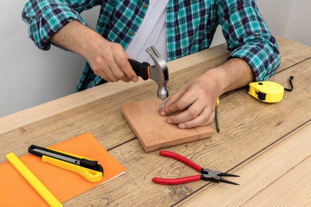 High view hands using hammer and nails