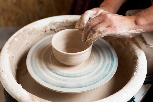 High view modeling of clay on a potter's wheel