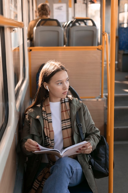 High view passenger holding a book and looking away