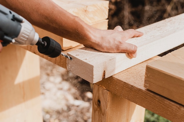 High view person holding a hammer drill